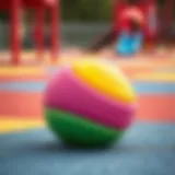 A vibrant soft ball resting on a playground surface
